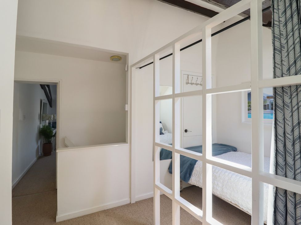 A bedroom with a bed and window at Cnicht View in Porthmadog