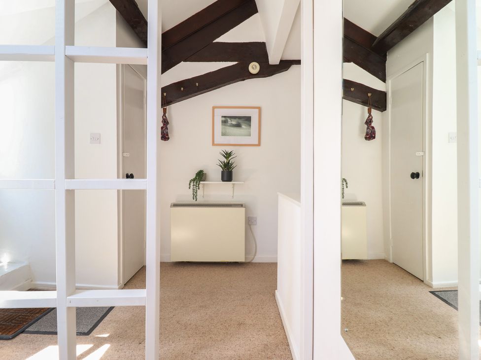 A hallway with a plant and picture frame at Cnicht View in Porthmadog