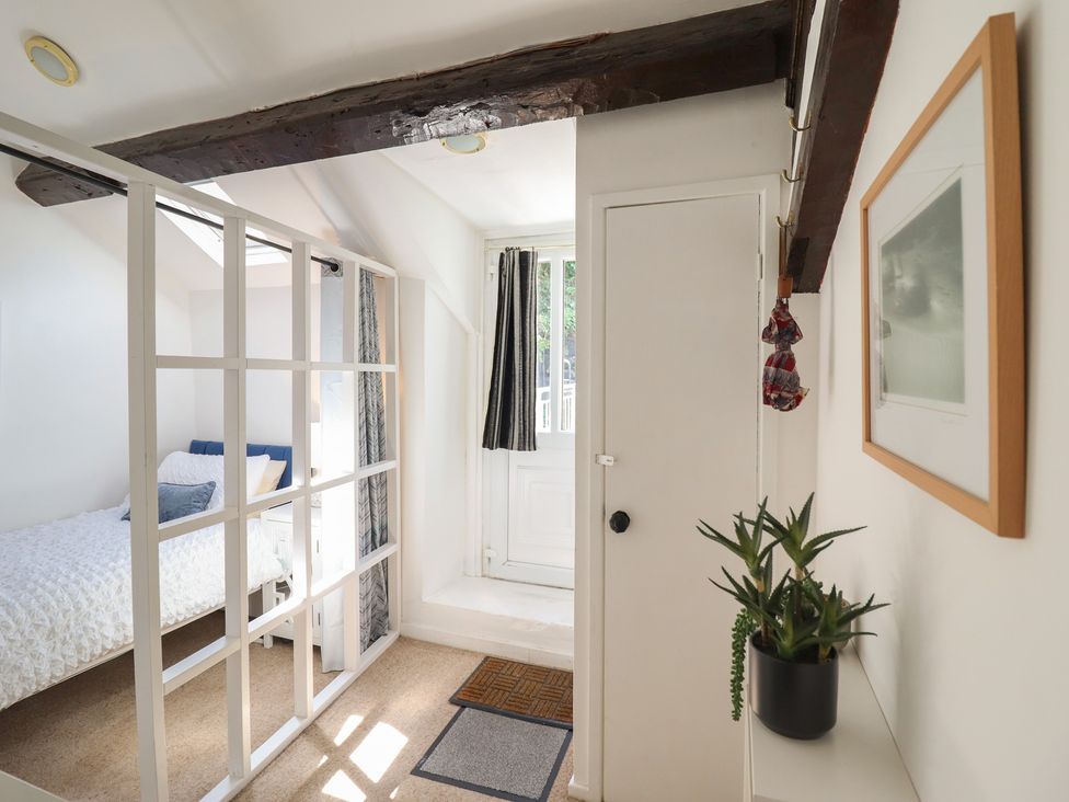 A bedroom with a bed and a door at Cnicht View in Porthmadog