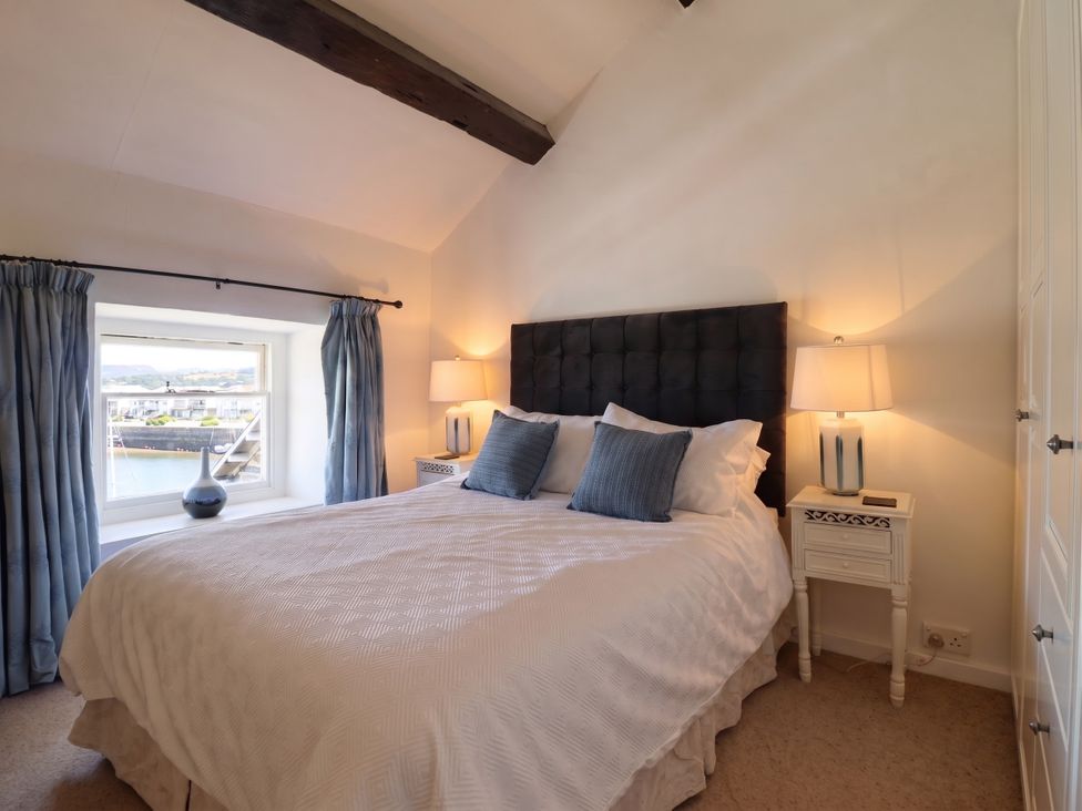 A bedroom with a bed and nightstands at Cnicht View, Porthmadog