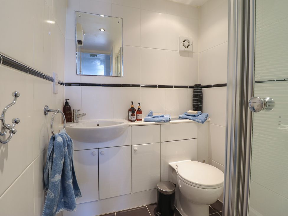 A bathroom with a sink and shower at Cnicht View in Porthmadog