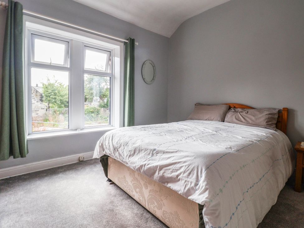 A bedroom with a bed and window at Burras Hill in Otley