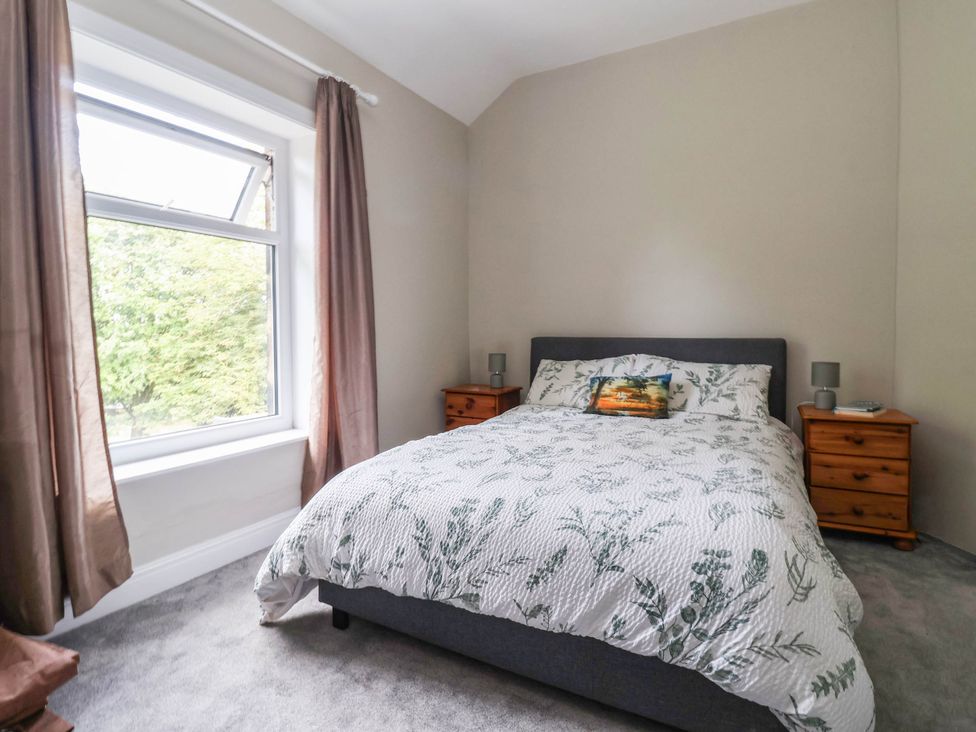 A bedroom with a bed and bedside tables at Burras Hill in Otley