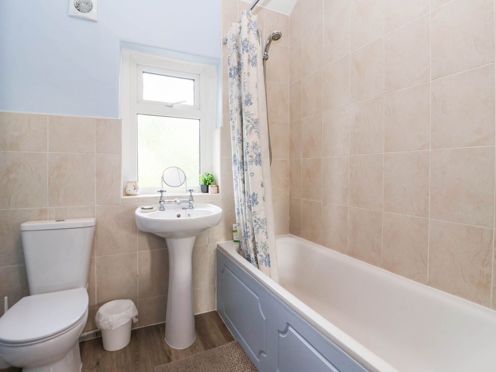 A bathroom with a toilet, sink, and bathtub at Burras Hill in Otley