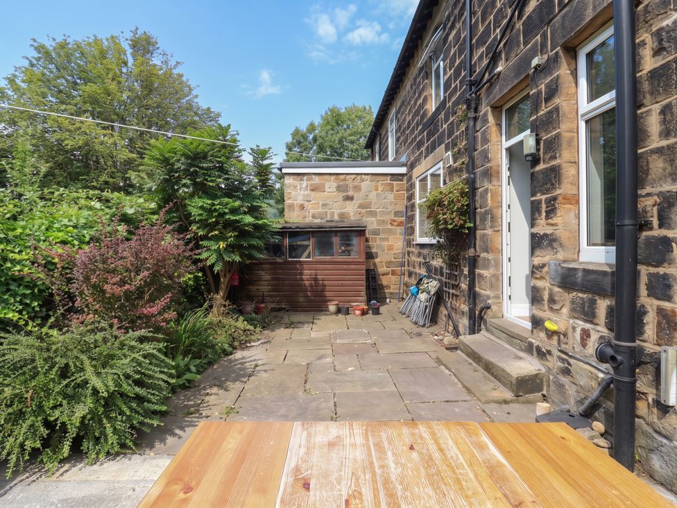 A garden with slate patio and plants at Burras Hill Otley
