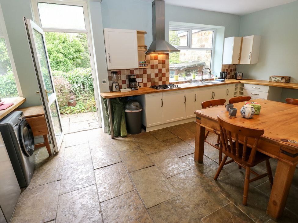 A kitchen with a wooden table and chairs at Burras Hill Otley