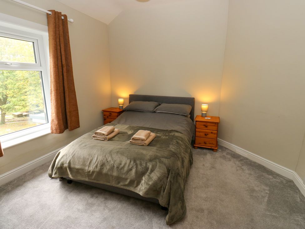 A bedroom with a bed and bedside tables at Burras Hill in Otley