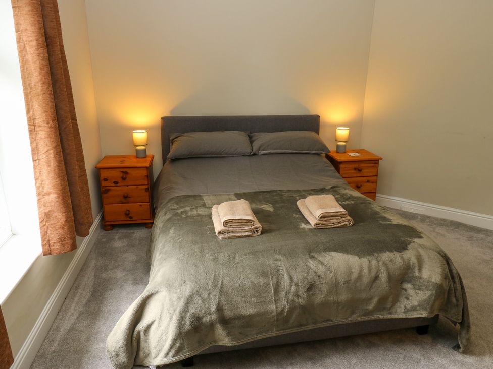 A bedroom with a bed and bedside tables at Burras Hill in Otley