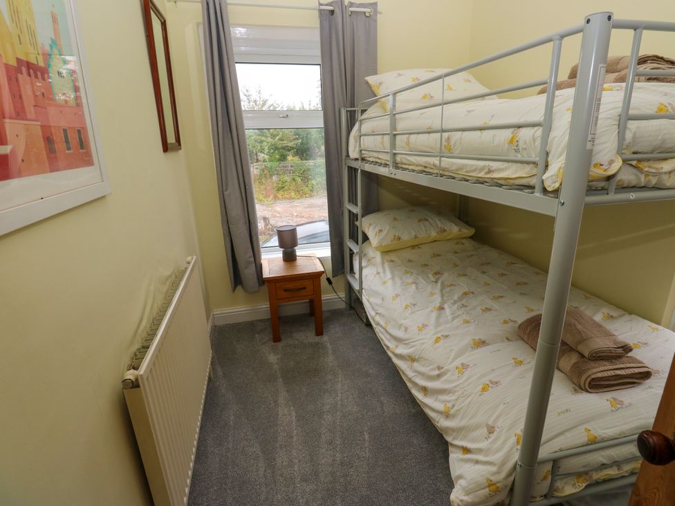 A bedroom with a bunk bed and nightstand at Burras Hill in Otley