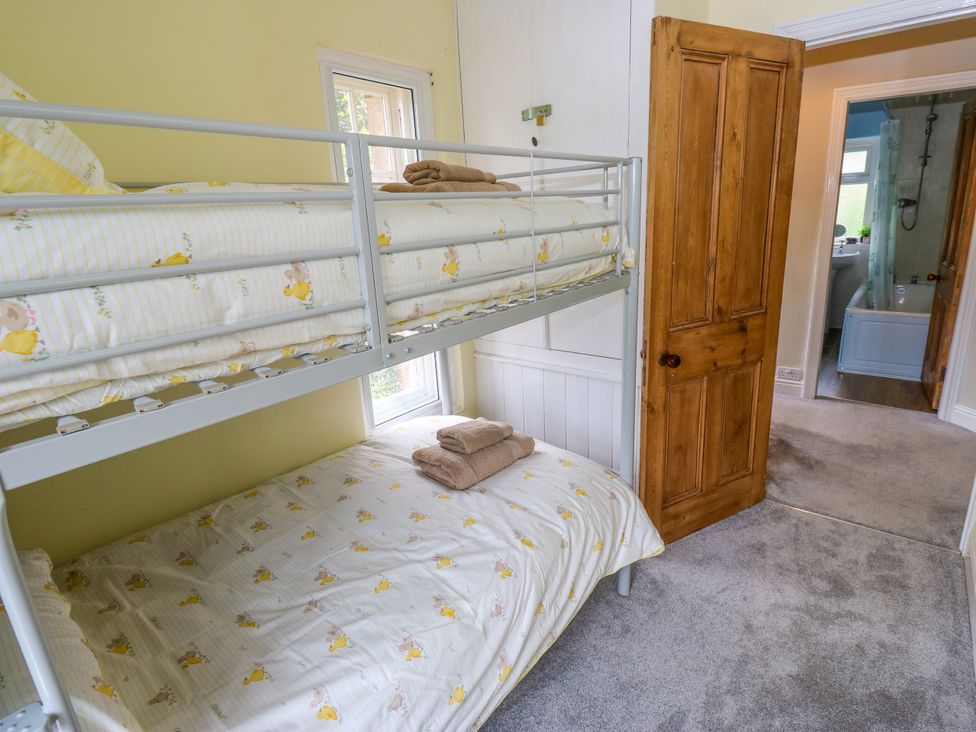 A bedroom with a bunk bed and towels at Burras Hill in Otley