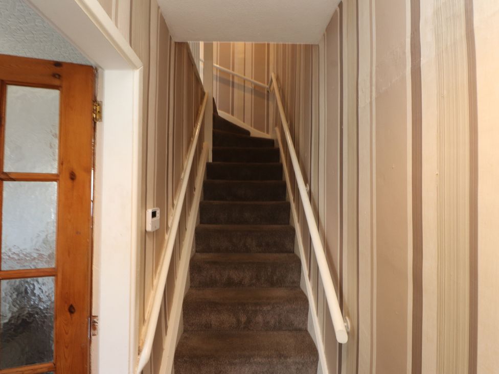 A staircase leading to an upper level in 31 Ffordd Y Maer Pwllheli