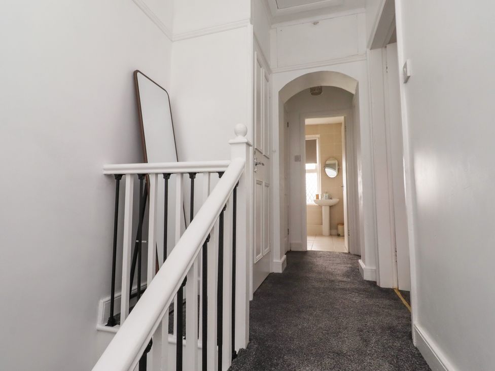 A hallway with a staircase and a bathroom in view at 19 Dunstan View Seahouses