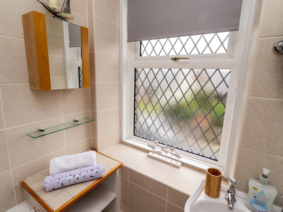 A bathroom with a window and sink at 19 Dunstan View in Seahouses