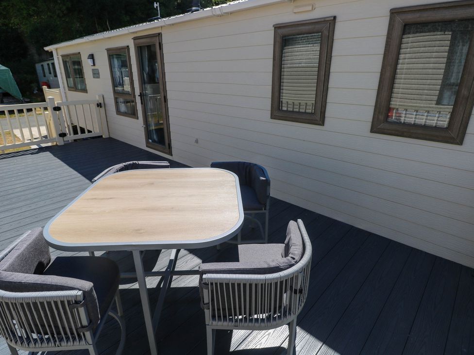 A table and chairs on a deck at Number 19 Ferryside