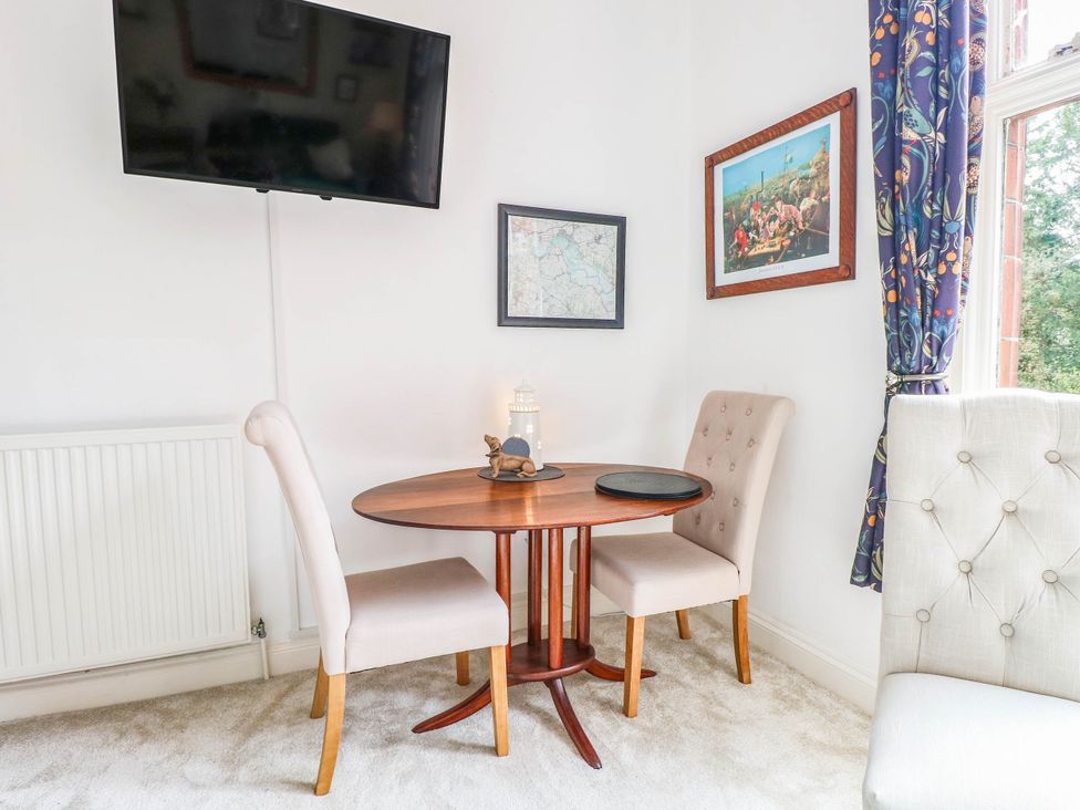 A dining area with a table and two chairs at 10 Uplands Court in Brundall