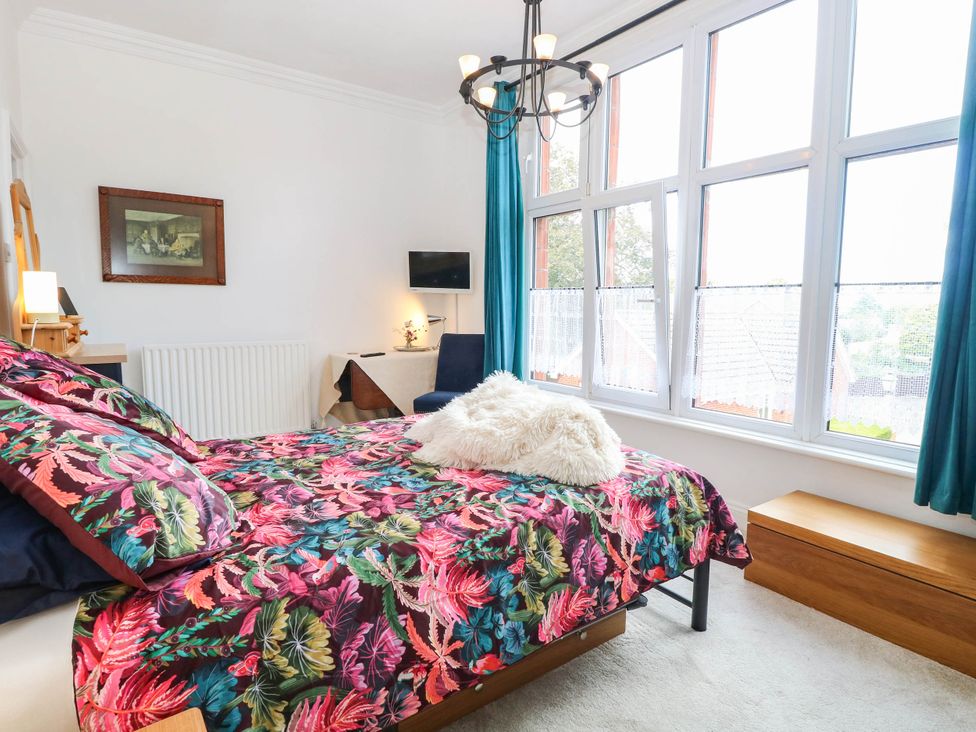 A bedroom with a bed and television at 10 Uplands Court in Brundall