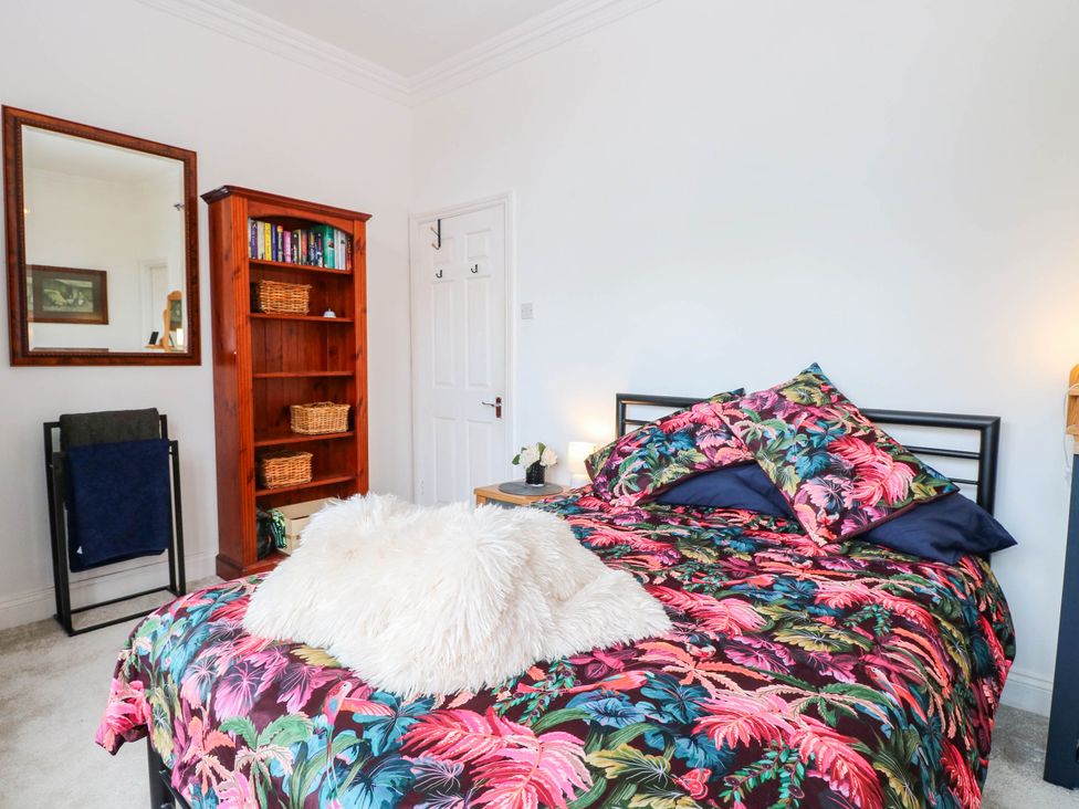 A bedroom with a bed and bookshelf at 10 Uplands Court in Brundall