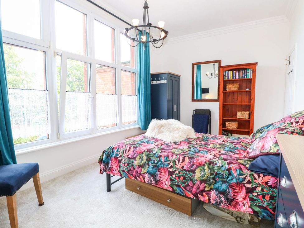 A bedroom with a bed and shelves at 10 Uplands Court Brundall