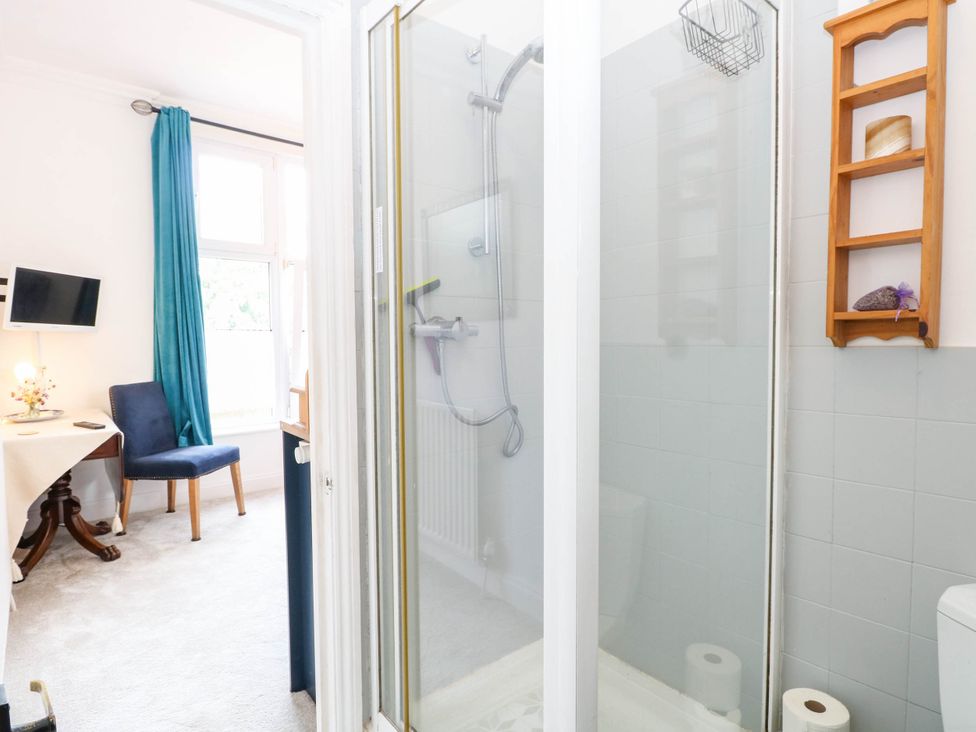 A bathroom with a shower, toilet, and sink at 10 Uplands Court in Brundall