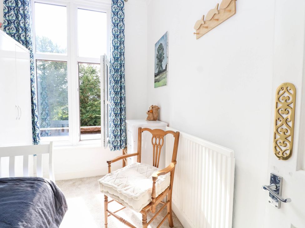 A bedroom with a bed and chair at 10 Uplands Court in Brundall