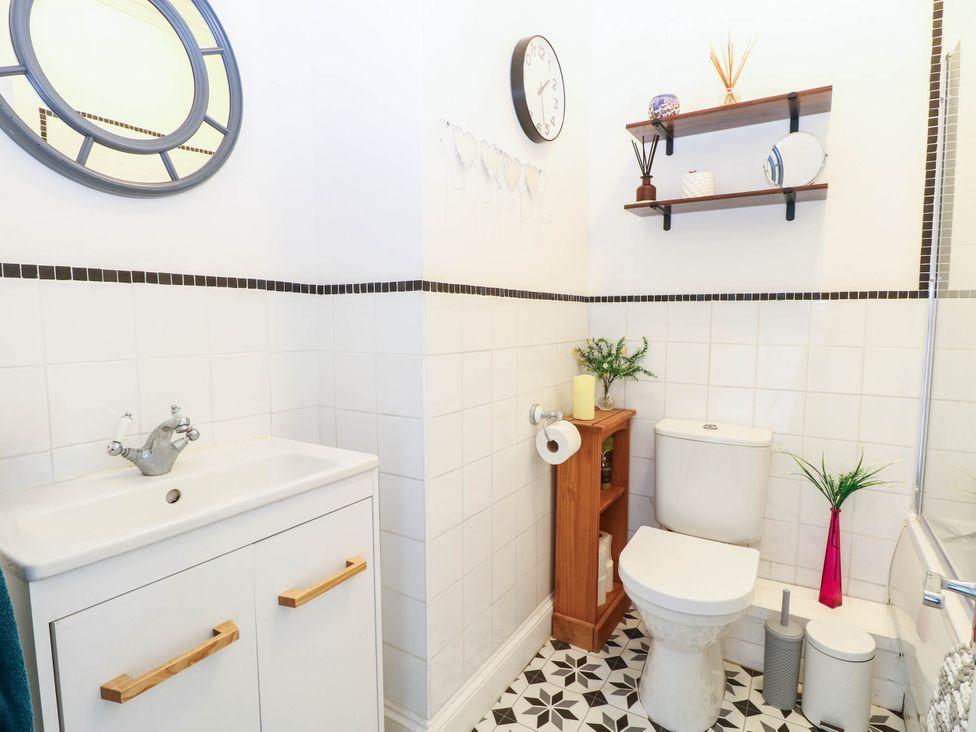 A bathroom featuring a wash basin and toilet at 10 Uplands Court Brundall