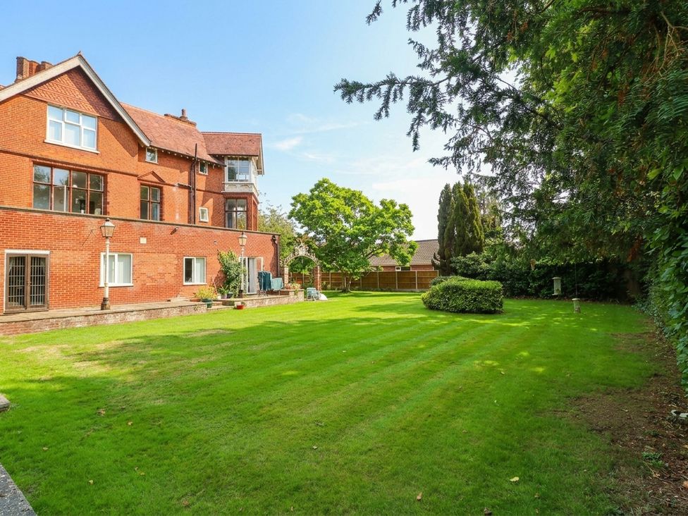 A garden area with grass and trees at 10 Uplands Court in Brundall