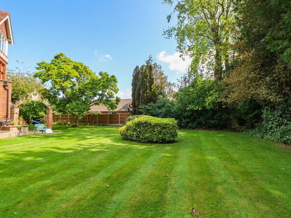 A garden with trimmed grass and trees at 10 Uplands Court in Brundall