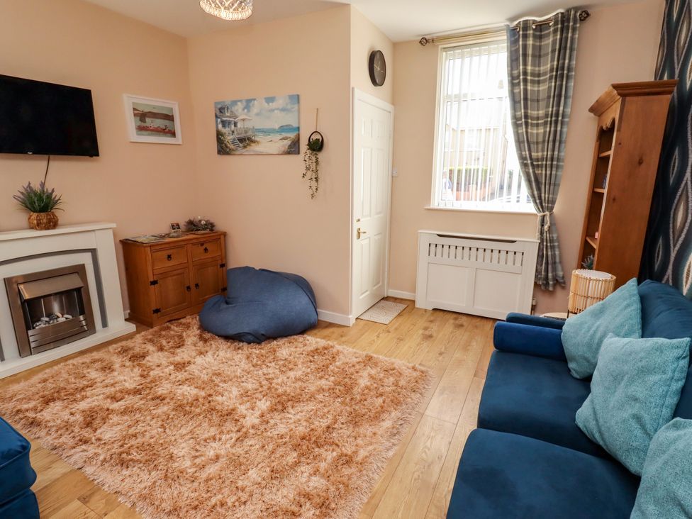 A living room with a sofa and a rug at The Old Bank House Red Row near Amble