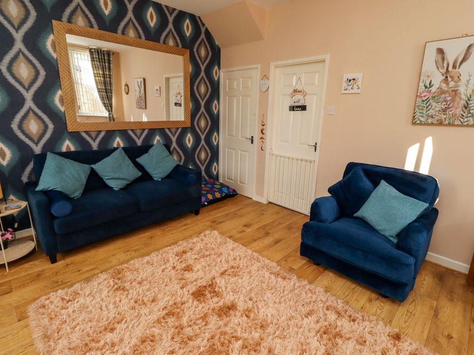 A living room with a sofa and chair at The Old Bank House near Amble
