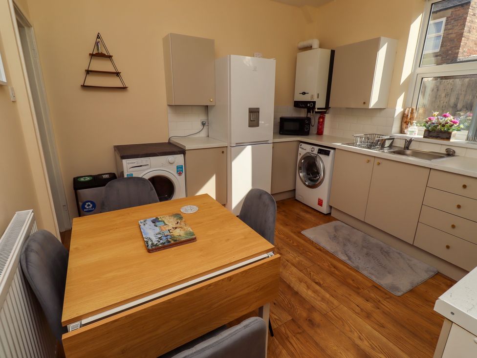 A kitchen with a table and chairs at The Old Bank House Red Row near Amble
