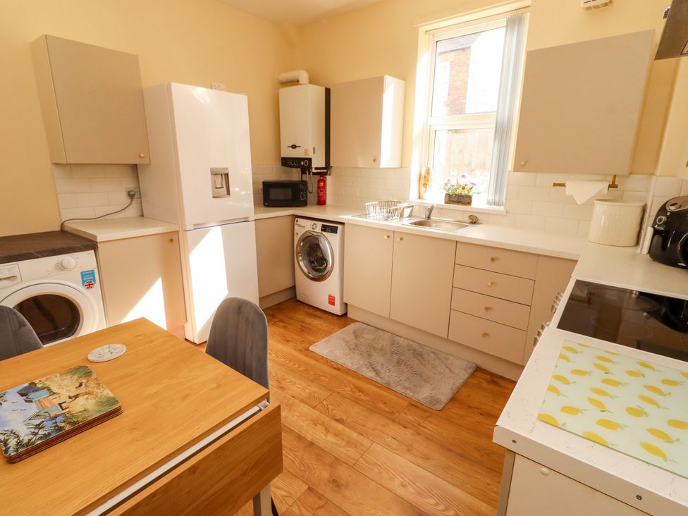 A kitchen with appliances and a table at The Old Bank House near Amble