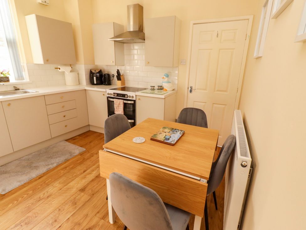 A kitchen with a table and chairs at The Old Bank House Red Row near Amble