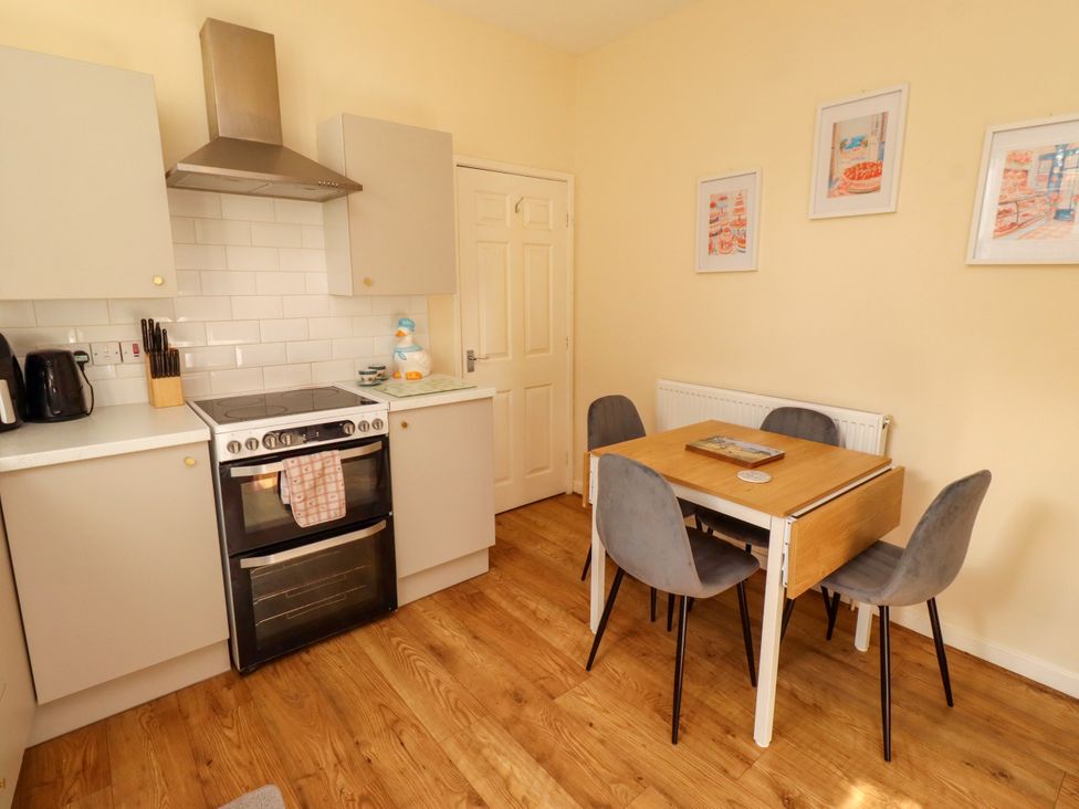 A kitchen with a dining table and chairs at The Old Bank House Red Row near Amble