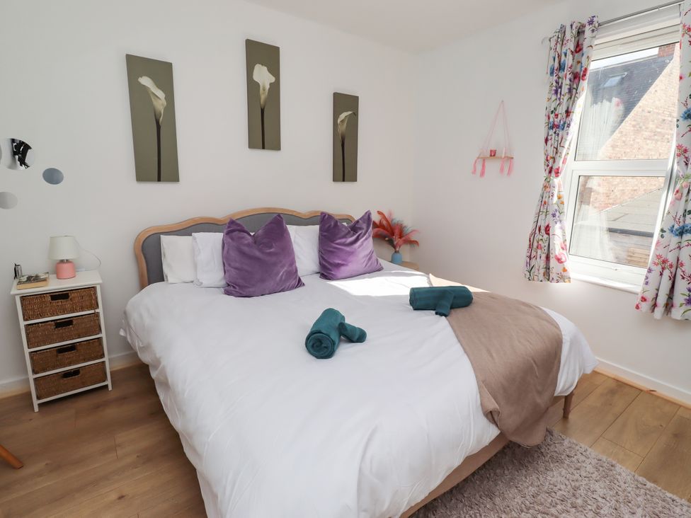 A bedroom with a bed and decorative pillows at The Old Bank House Red Row near Amble