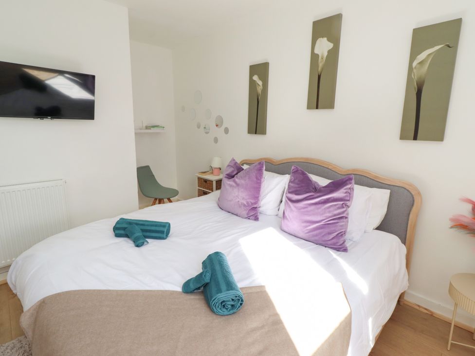 A bedroom with a bed and television at The Old Bank House Red Row near Amble