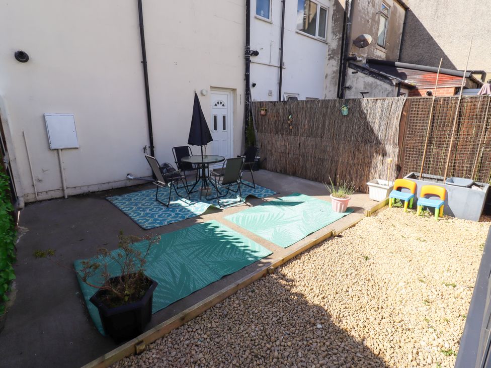 An outdoor area with a table and chairs at The Old Bank House Red Row near Amble