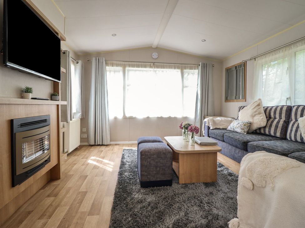A living room with a television and sofa at Plot 13A