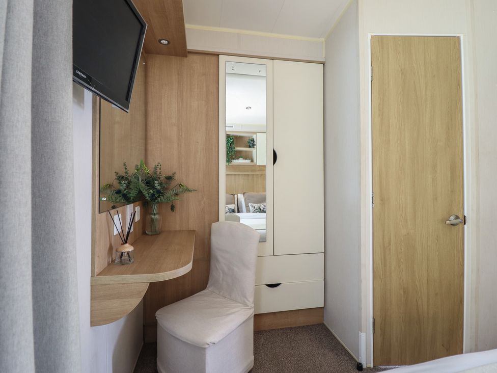 A bedroom with a mirror and desk at Plot 13A in 