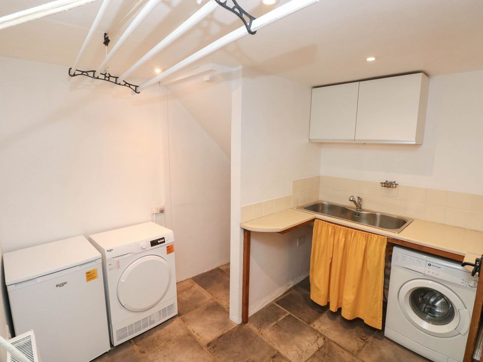 A laundry room with washing machine and dryer at Penrhiwoli Barn Cefn Gorwydd