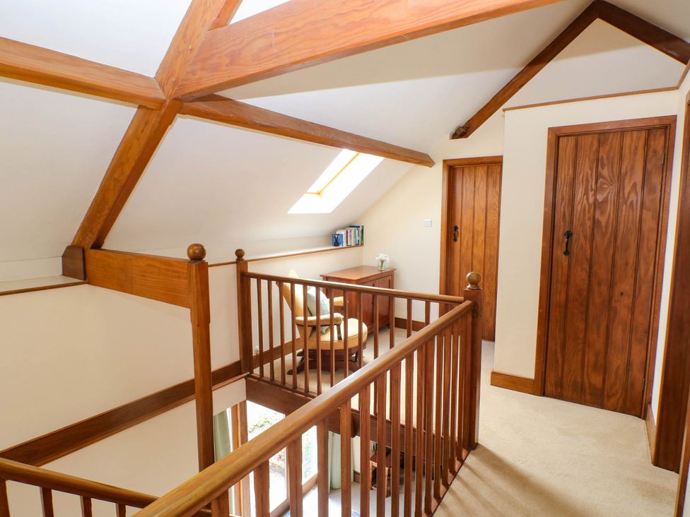 A landing with a desk and chair at Penrhiwoli Barn Cefn Gorwydd