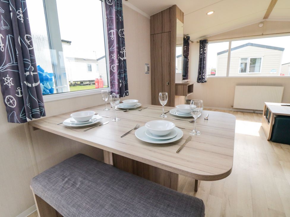 A dining room with a table set for a meal at 42 Oak Green