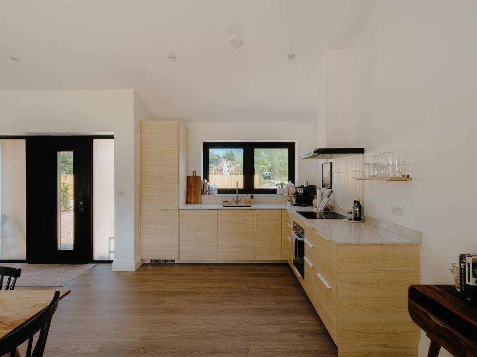 A kitchen with cabinets and a sink at Baldslow Barn Battle near Hastings