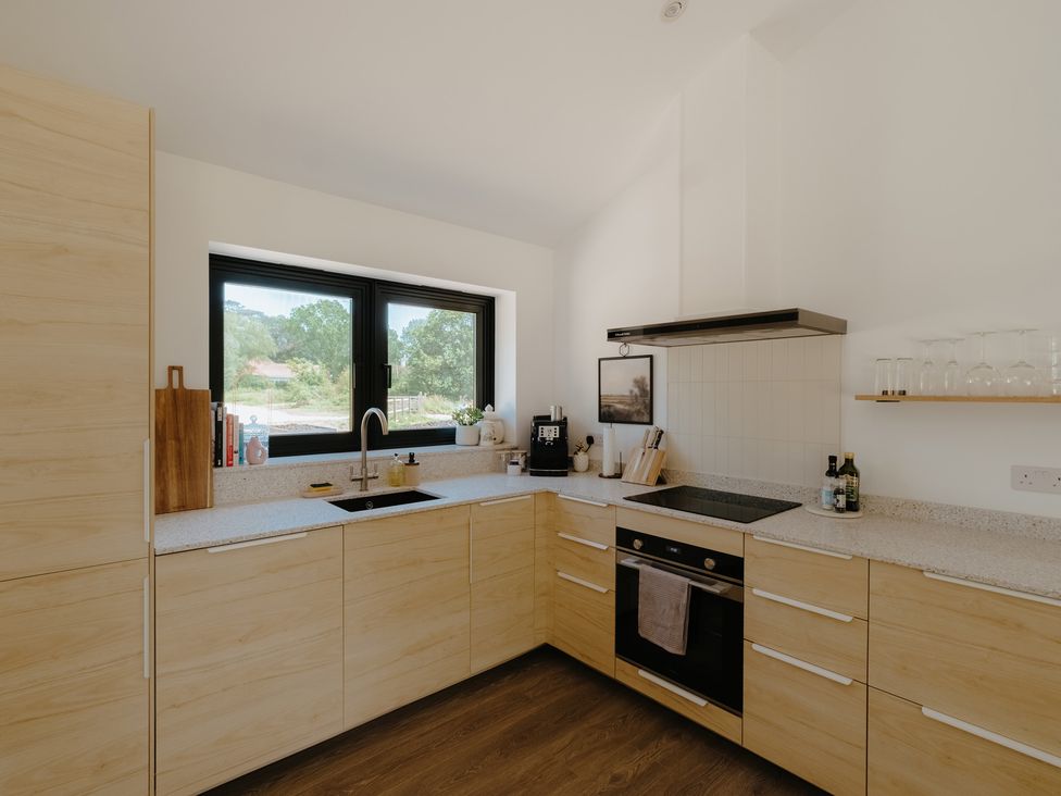 A kitchen with a sink and oven at Baldslow Barn in Battle near Hastings