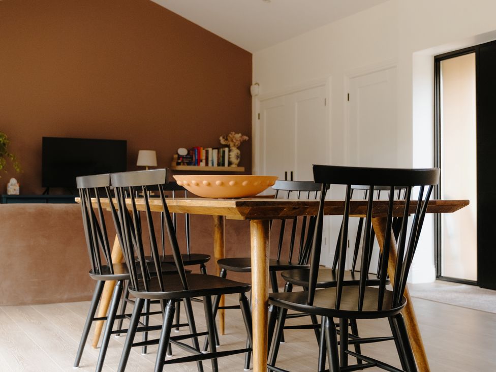 A dining room with a table and chairs at Baldslow Barn in Battle near Hastings