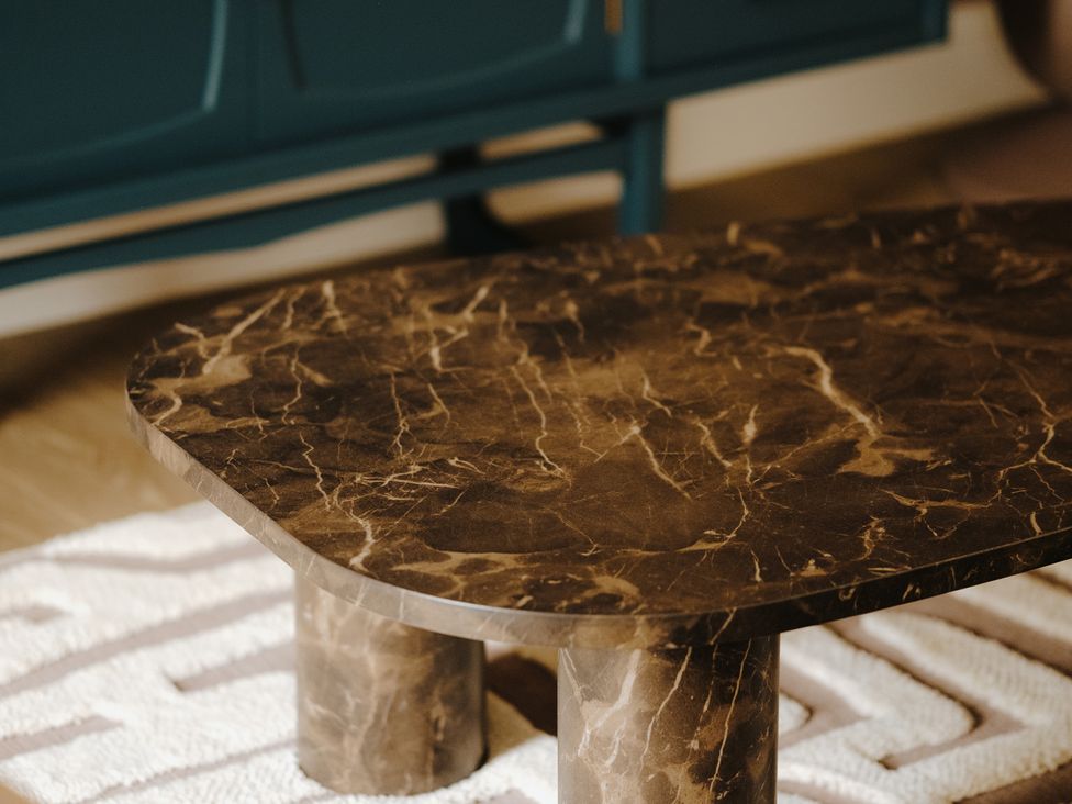 A table on a rug in a living room at Baldslow Barn near Hastings