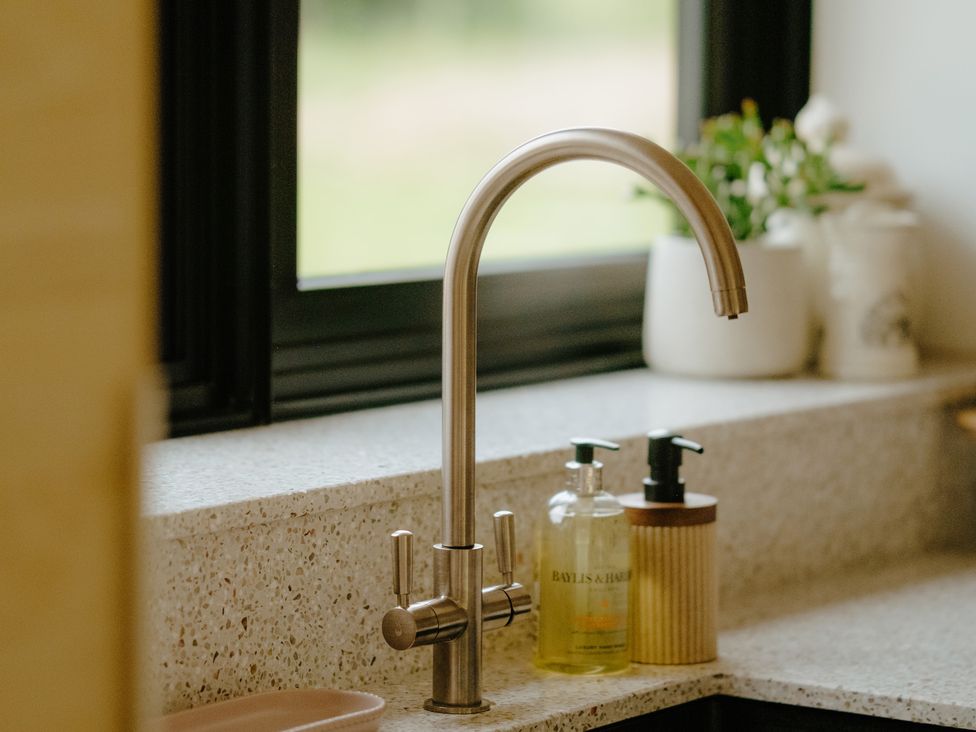 A kitchen with a sink and faucet at Baldslow Barn Battle near Hastings