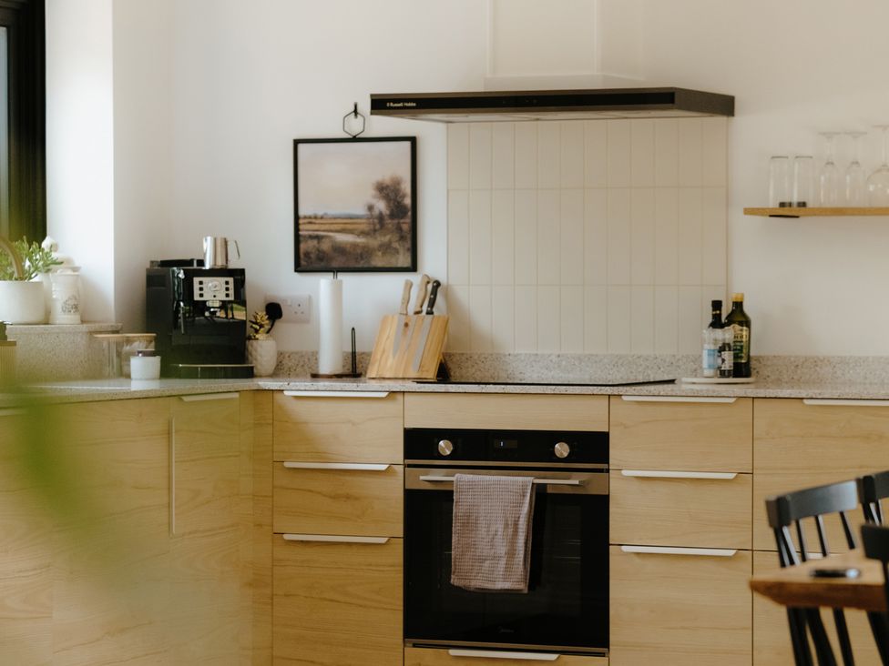 A kitchen with cabinets and a coffee machine at Baldslow Barn in Battle near Hastings