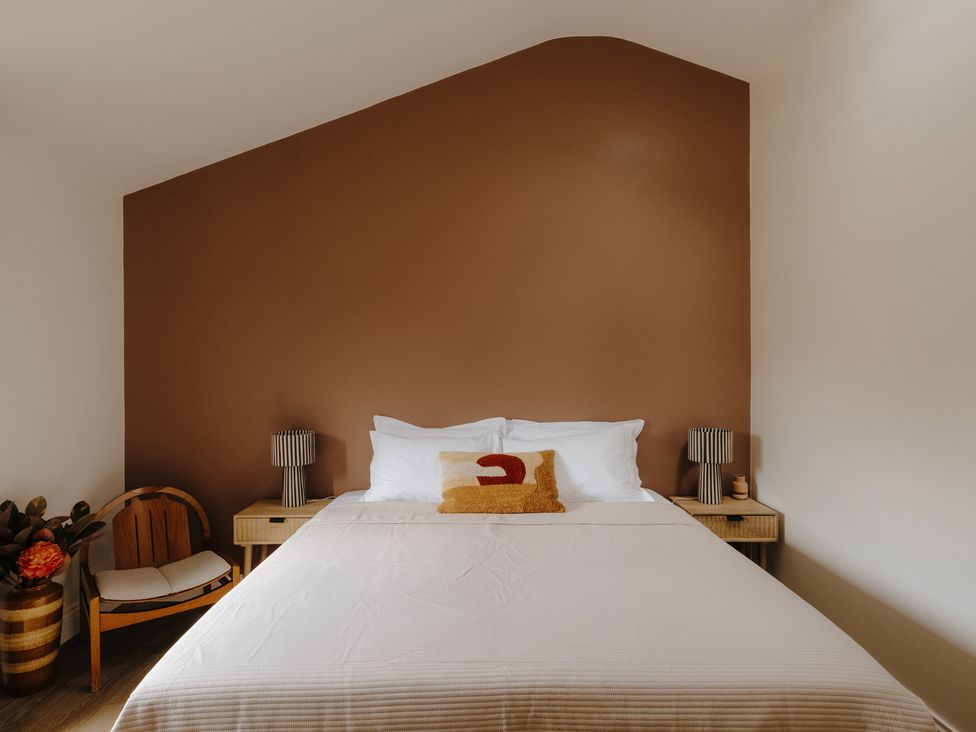 A bedroom with a bed and bedside tables at Baldslow Barn in Battle near Hastings