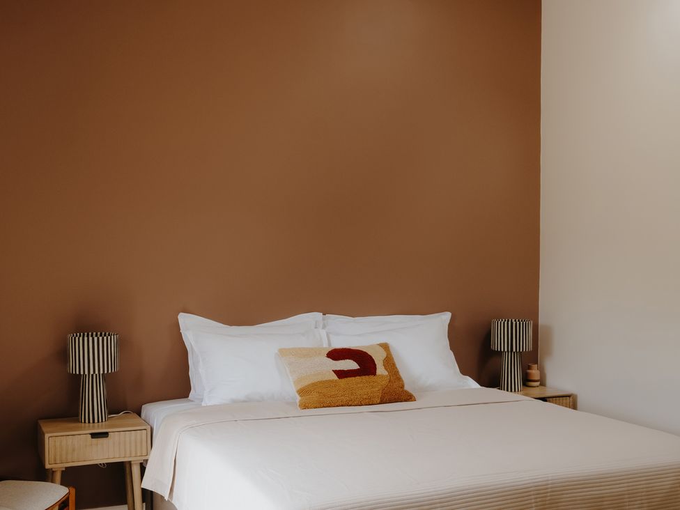 A bedroom with a bed and bedside tables at Baldslow Barn near Hastings