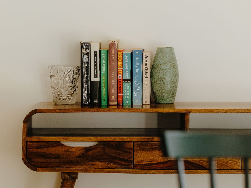 A shelf displaying books and a vase at Baldslow Barn Battle near Hastings
